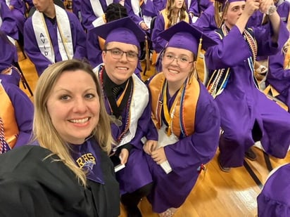 A photo of AVID graduates with their AVID teacher.